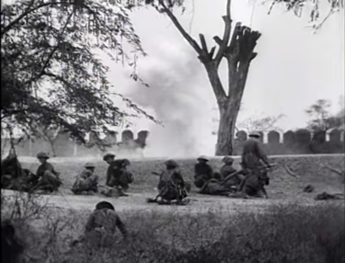 Infantry shelter beihind a smokescreen during the attack on Fort Dufferin, 10th March 1945